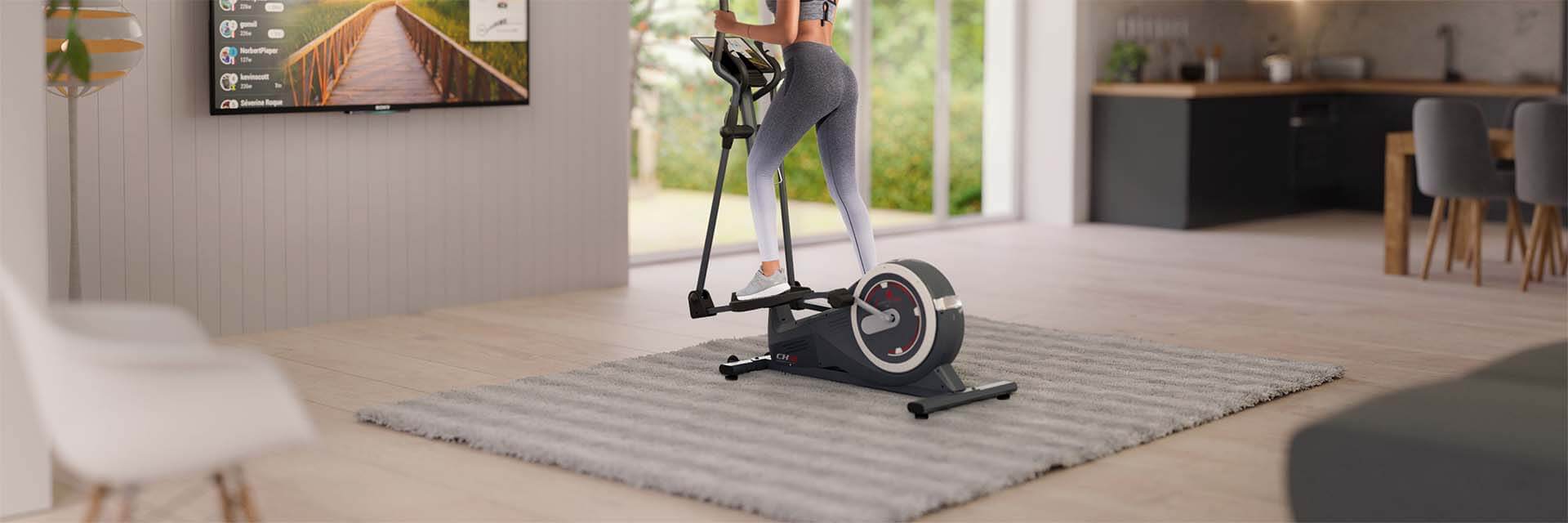 Crosstrainer CX625 von Sportstech Frau in Sportbekleidung trainiert auf dem CX625 Crosstrainer im Wohnzimmer und verwendet die Fitness App auf dem TV